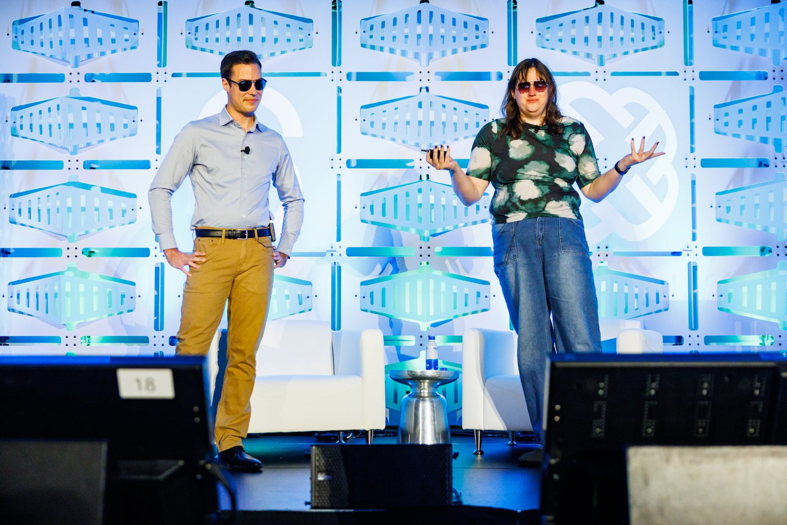 Two Valkey speakers presenting on a conference stage
