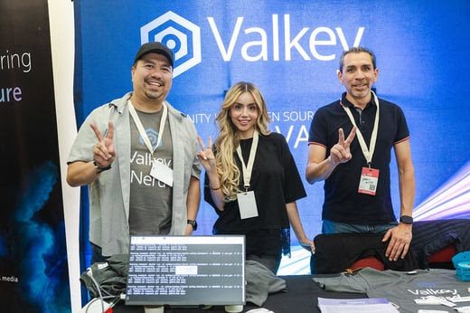 Valkey team members greeting visitors at a conference booth